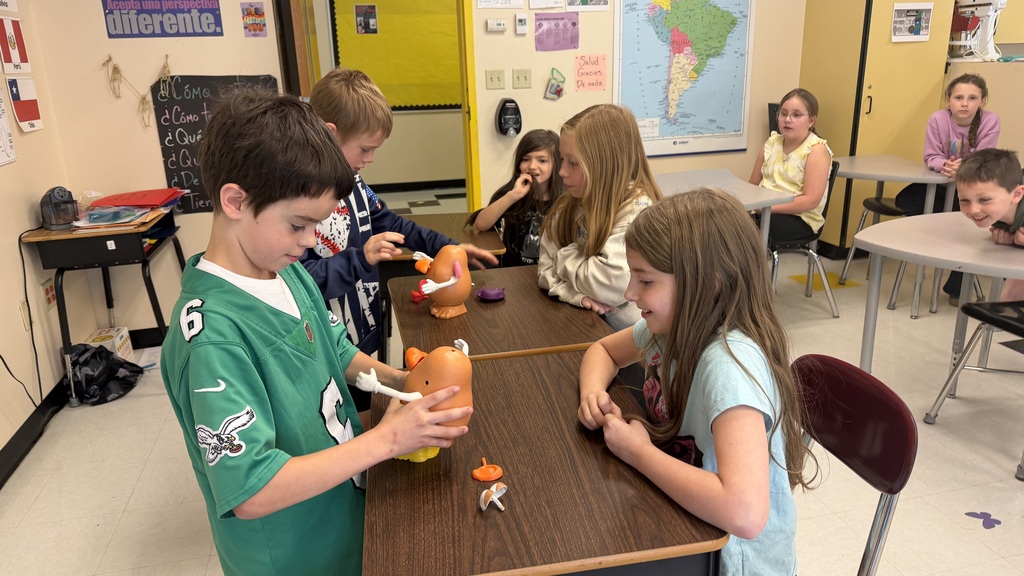 Third grade students participate in interactive Spanish language activities, including games and hands-on learning focused on body parts vocabulary.