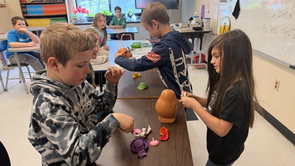 Third grade students participate in interactive Spanish language activities, including games and hands-on learning focused on body parts vocabulary.