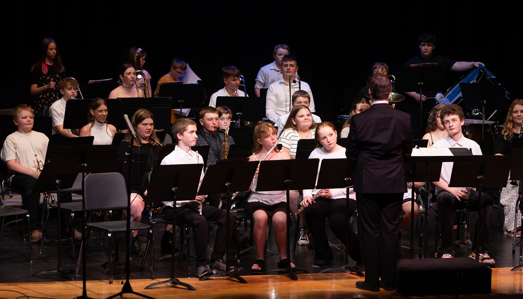 Photos from the Otselic Valley Spring Band and Chorus Concert featuring student musicians and vocalists performing on stage.