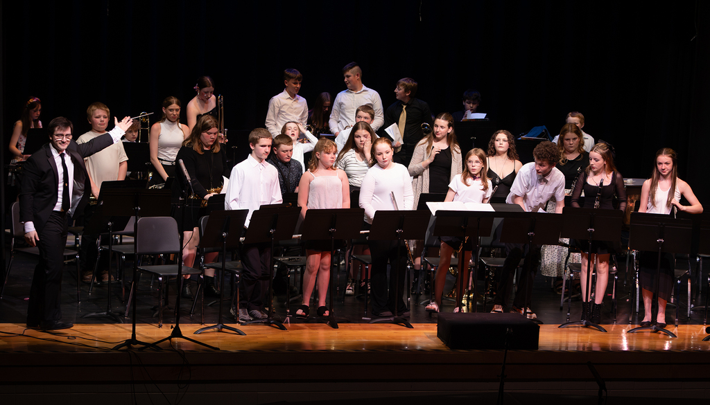 Photos from the Otselic Valley Spring Band and Chorus Concert featuring student musicians and vocalists performing on stage.