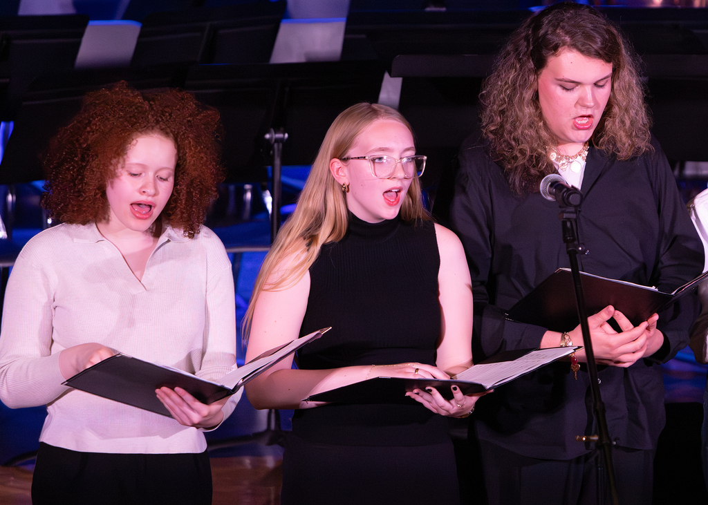 Photos from the Otselic Valley Spring Band and Chorus Concert featuring student musicians and vocalists performing on stage.