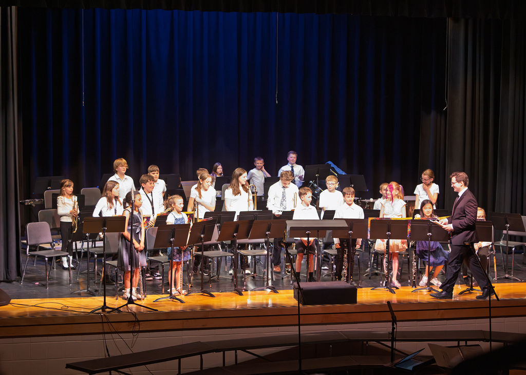 Photos from the Otselic Valley Spring Band and Chorus Concert featuring student musicians and vocalists performing on stage.