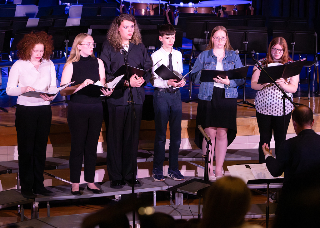 Photos from the Otselic Valley Spring Band and Chorus Concert featuring student musicians and vocalists performing on stage.