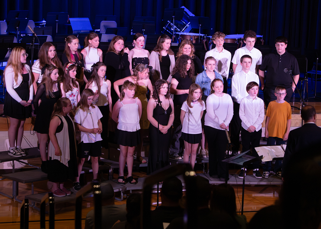Photos from the Otselic Valley Spring Band and Chorus Concert featuring student musicians and vocalists performing on stage.