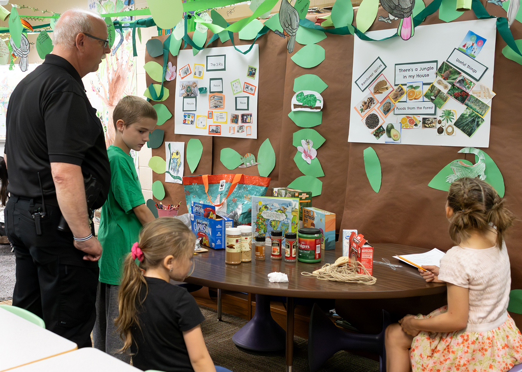 Photos from the “Welcome to the Jungle” rainforest classroom tour featuring student-created displays, artwork, and interactive learning experiences.
