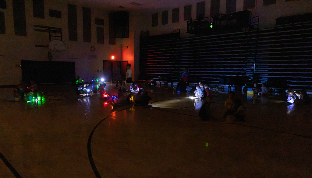 Kindergarten through second grade students participate in Flashlight Reading as part of the ABC Countdown to Summer, using flashlights while reading together with classmates.