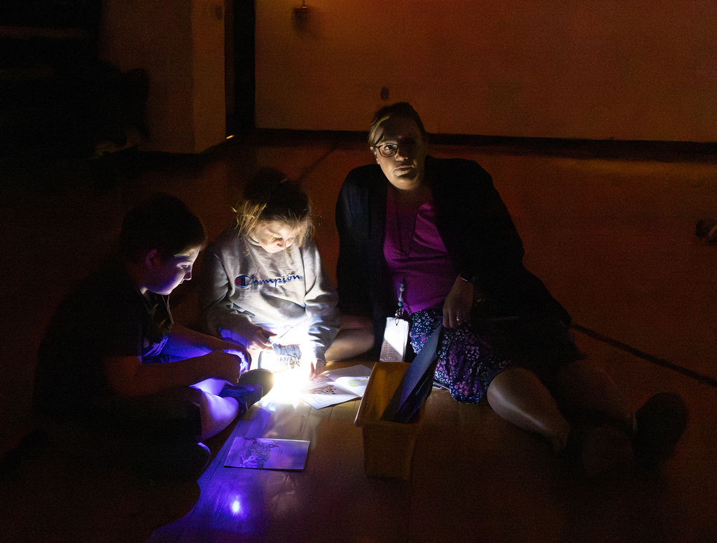 Kindergarten through second grade students participate in Flashlight Reading as part of the ABC Countdown to Summer, using flashlights while reading together with classmates.