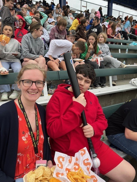 Students and staff attending a Syracuse Mets game during an OV incentive trip. Photos show students at the ballpark, in the stands, and enjoying the day together.