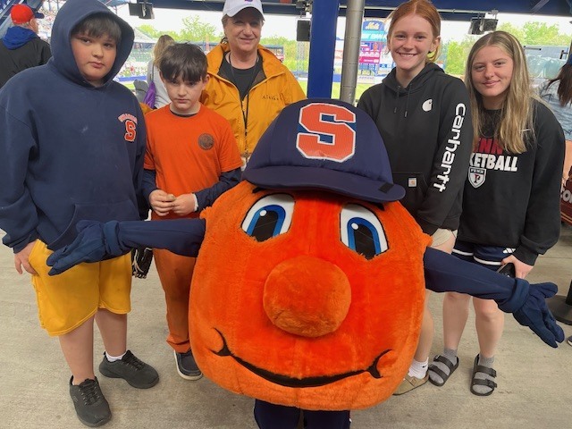 Students and staff attending a Syracuse Mets game during an OV incentive trip. Photos show students at the ballpark, in the stands, and enjoying the day together.