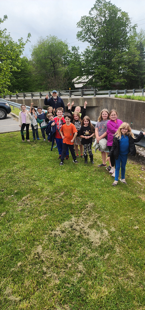 Students from Mr. Gross' class gather near a local stream as they participate in the release of brook trout raised through the Trout in the Classroom program.