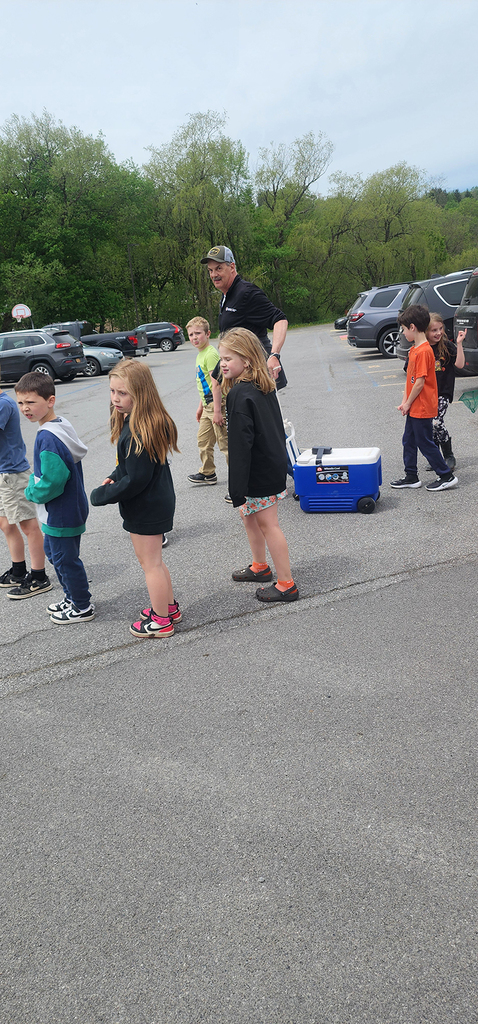 Students from Mr. Gross' class gather near a local stream as they participate in the release of brook trout raised through the Trout in the Classroom program.