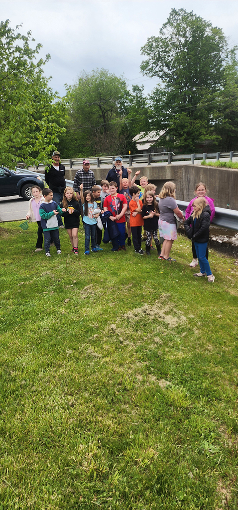 Students from Mr. Gross' class gather near a local stream as they participate in the release of brook trout raised through the Trout in the Classroom program.