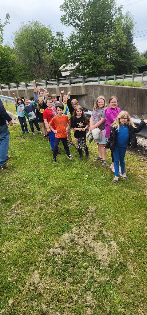 Students from Mr. Gross' class gather near a local stream as they participate in the release of brook trout raised through the Trout in the Classroom program.