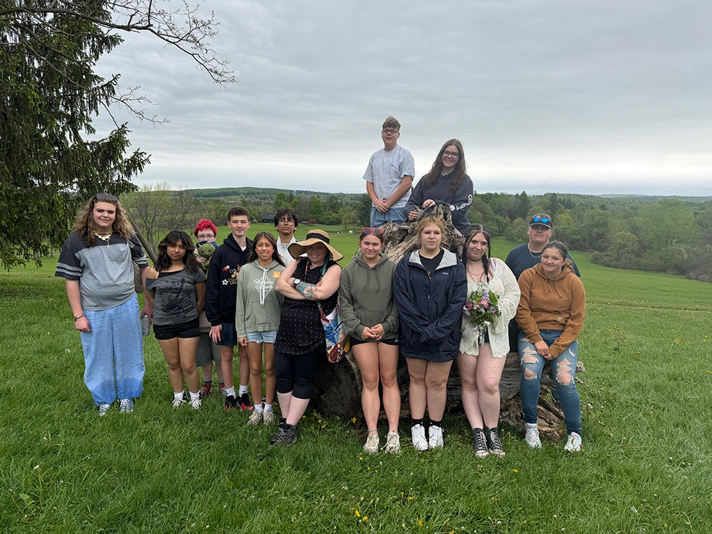 Students explore outdoor art installations and hiking trails during a field trip to Stone Quarry Art Park in Cazenovia. Photos show students enjoying nature, viewing artwork, and spending time outdoors with classmates.