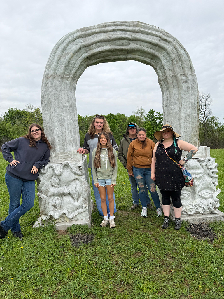 Students explore outdoor art installations and hiking trails during a field trip to Stone Quarry Art Park in Cazenovia. Photos show students enjoying nature, viewing artwork, and spending time outdoors with classmates.