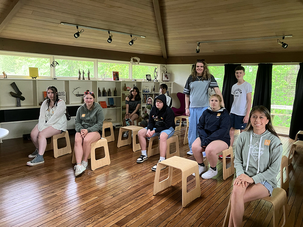 Students explore outdoor art installations and hiking trails during a field trip to Stone Quarry Art Park in Cazenovia. Photos show students enjoying nature, viewing artwork, and spending time outdoors with classmates.