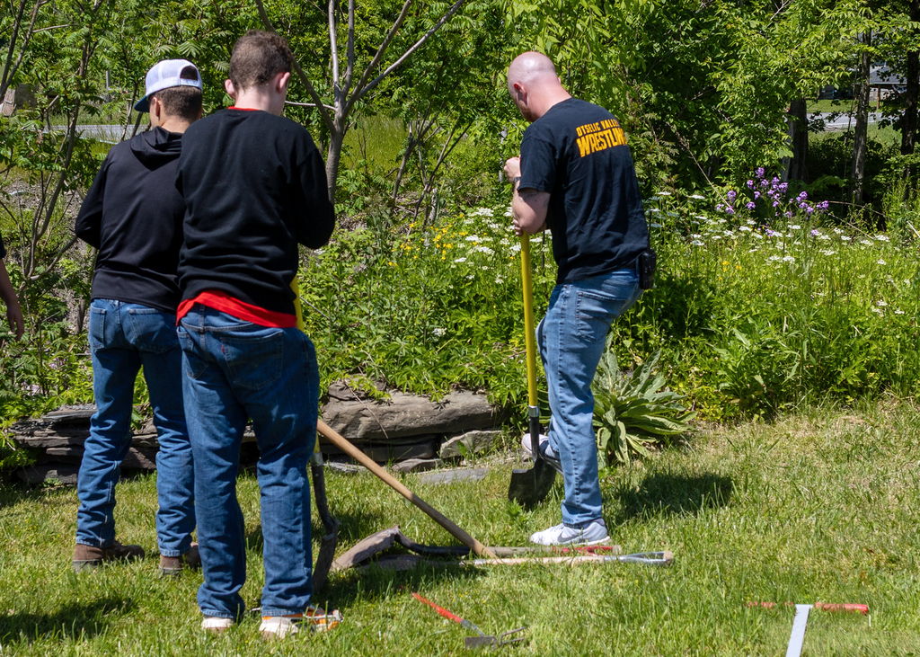 Middle school students plant young willow trees along the bank of Ashbell Brook near Otselic Valley school property as part of an erosion prevention and environmental stewardship project.