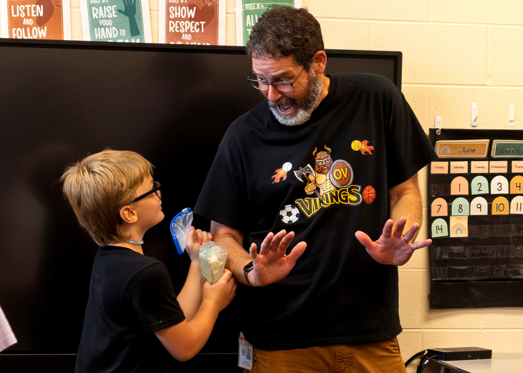 Mrs. Marston's second grade students work together to make homemade ice cream with Mr. Harvey. Students take turns helping with the process and enjoy tasting the finished treat.