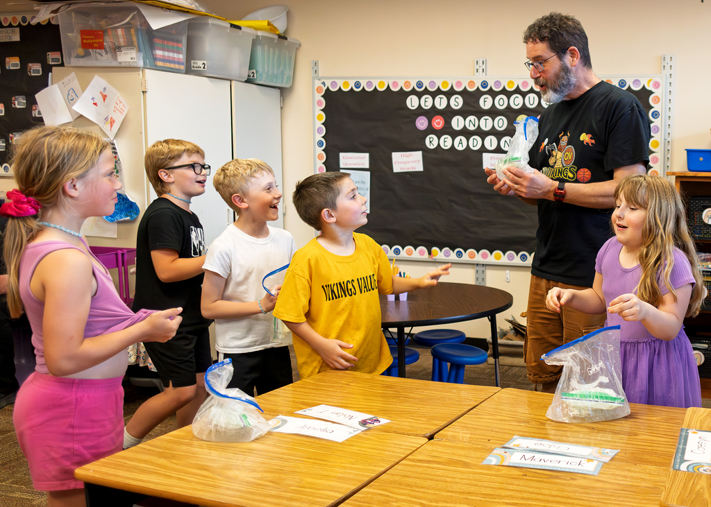 Mrs. Marston's second grade students work together to make homemade ice cream with Mr. Harvey. Students take turns helping with the process and enjoy tasting the finished treat.