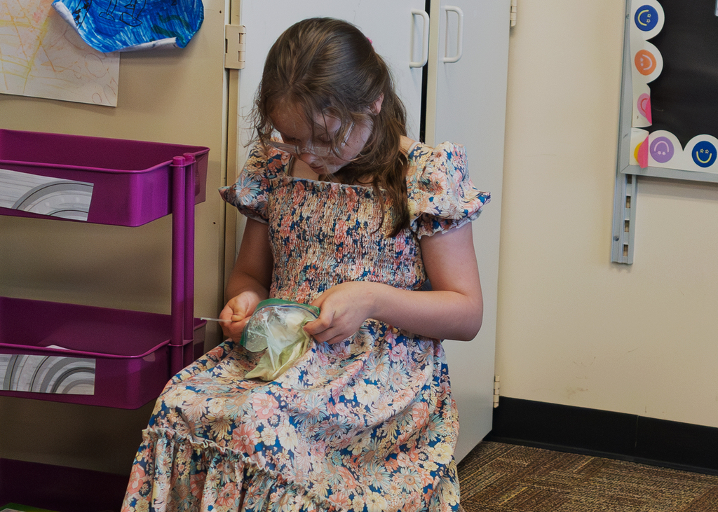 Mrs. Marston's second grade students work together to make homemade ice cream with Mr. Harvey. Students take turns helping with the process and enjoy tasting the finished treat.