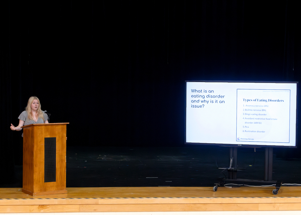 Otselic Valley seniors present their Civic Action Projects during the Voices for Change event. Students speak to an audience while sharing research, community concerns, and action plans developed throughout the school year.