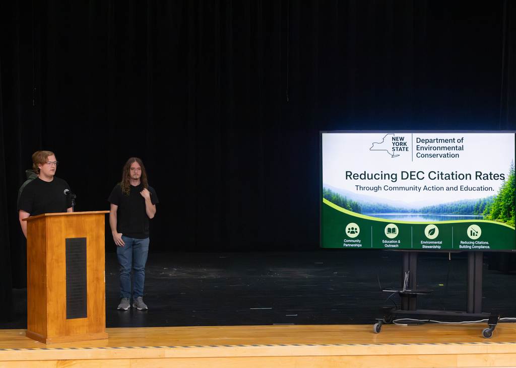 Otselic Valley seniors present their Civic Action Projects during the Voices for Change event. Students speak to an audience while sharing research, community concerns, and action plans developed throughout the school year.