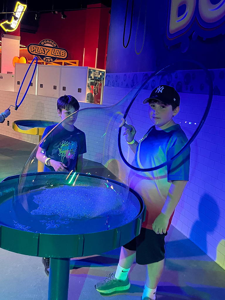 Students explore interactive exhibits and attractions at WonderWorks.