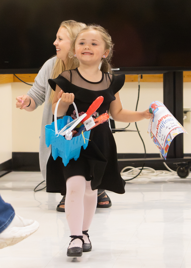 Pre-K students participate in an end-of-year celebration with staff and families.