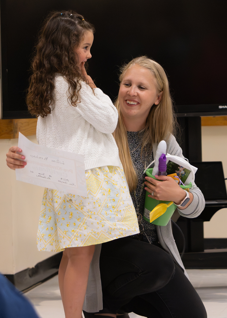 Pre-K students participate in an end-of-year celebration with staff and families.