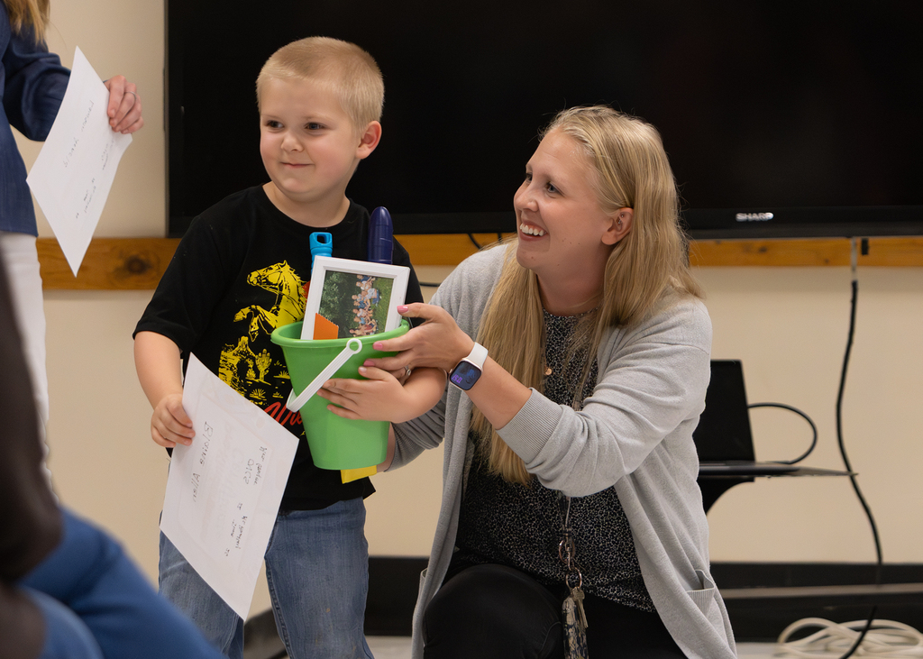 Pre-K students participate in an end-of-year celebration with staff and families.