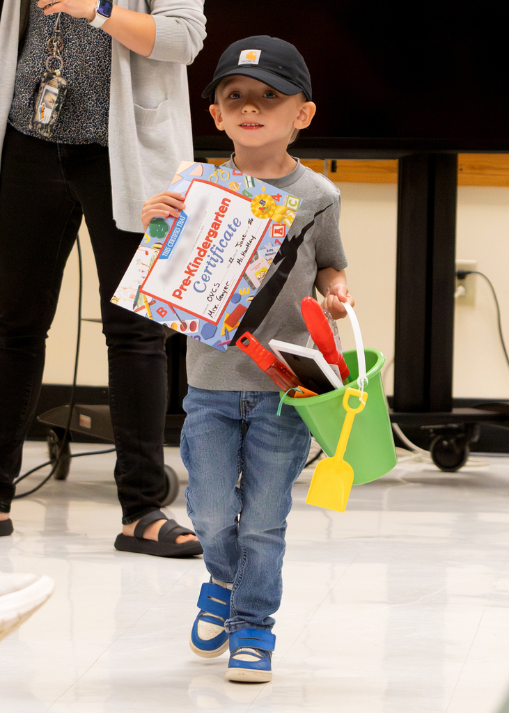 Pre-K students participate in an end-of-year celebration with staff and families.