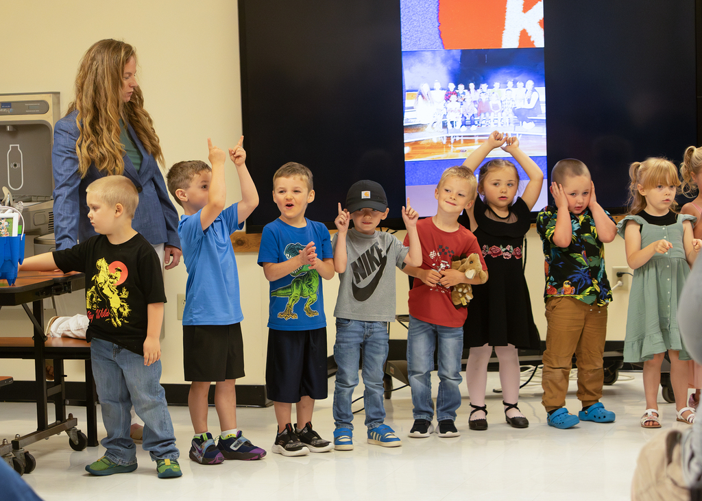 Pre-K students participate in an end-of-year celebration with staff and families.