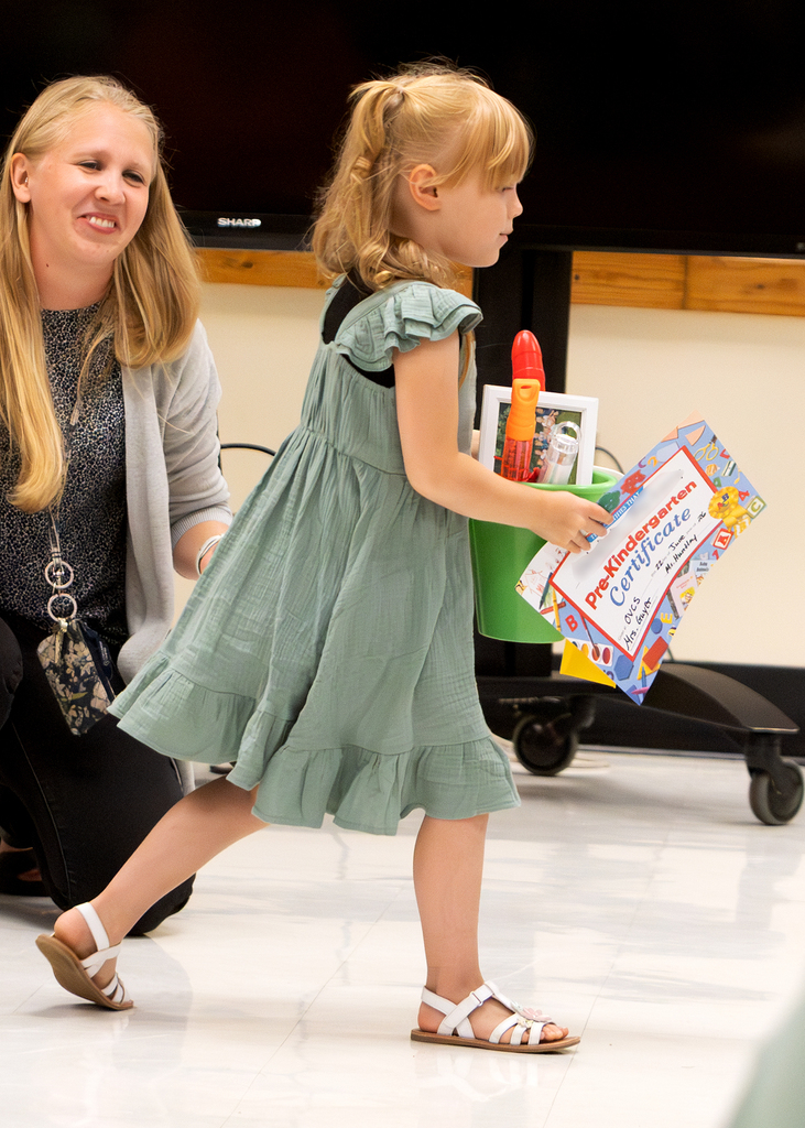 Pre-K students participate in an end-of-year celebration with staff and families.
