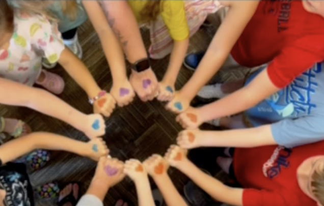 Kindergarten hands in a circle with hearts on them