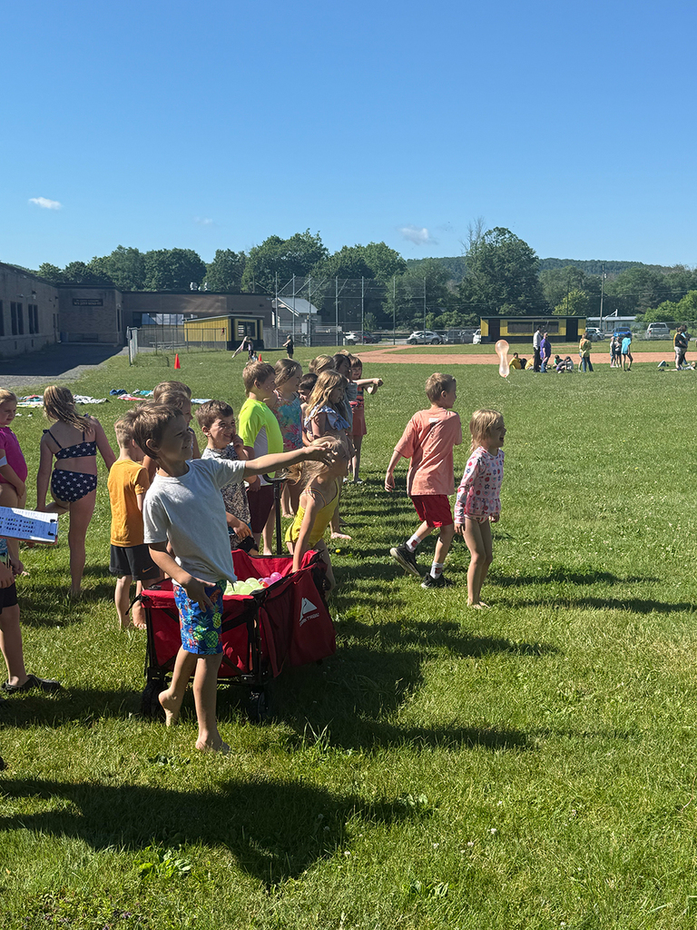 Elementary students enjoy Water Day outdoors, celebrating the end of the school year with fun activities and water balloons.