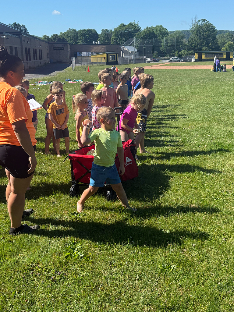 Elementary students enjoy Water Day outdoors, celebrating the end of the school year with fun activities and water balloons.