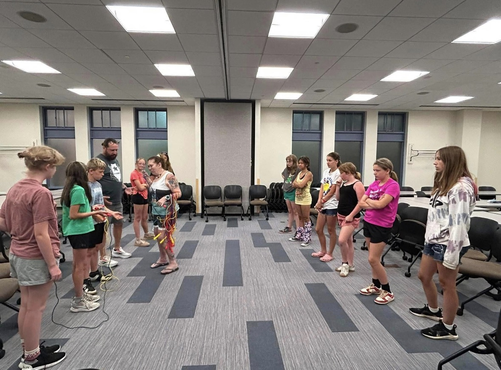 A group of students standing in two lines facing each other