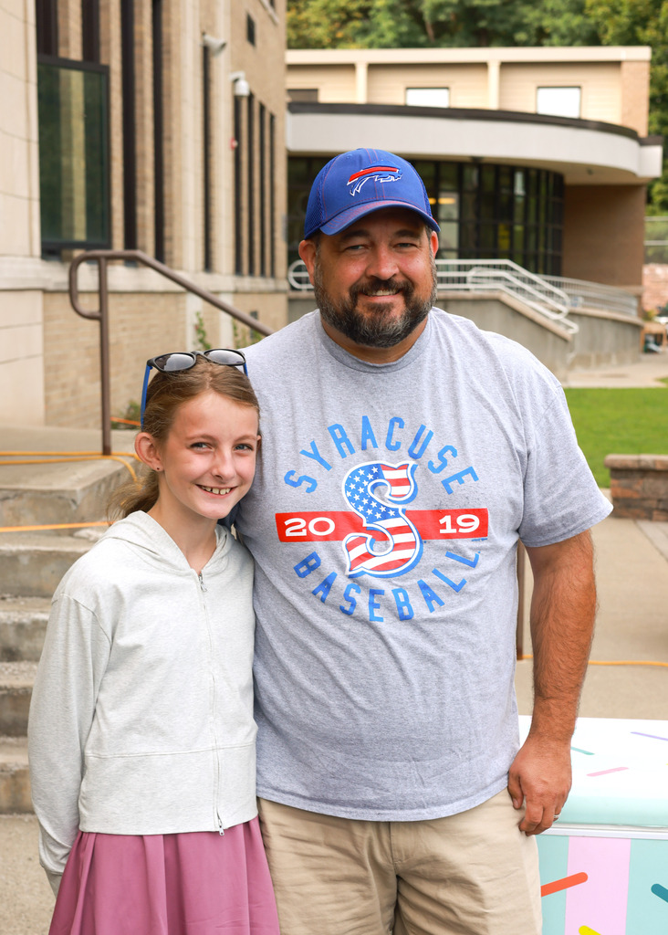 Father and daughter stand outside