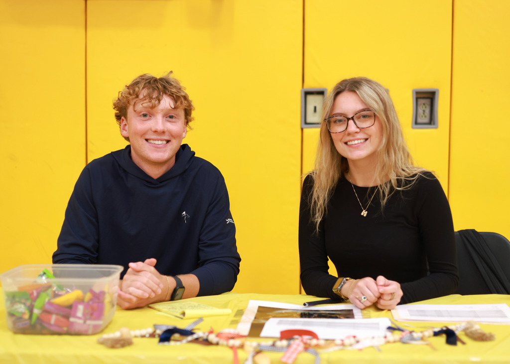 Two high schoolers sitting at a table