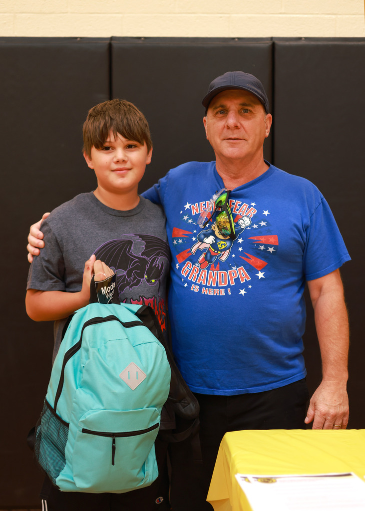 Dad and son stand with new backpack