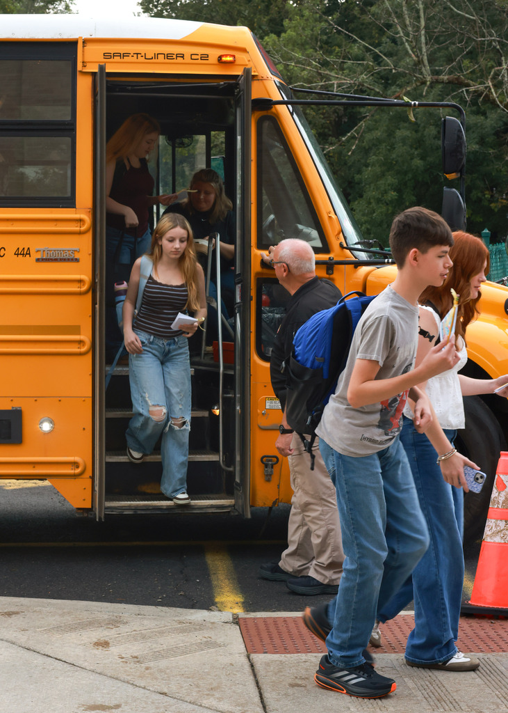 Students walk off of bus