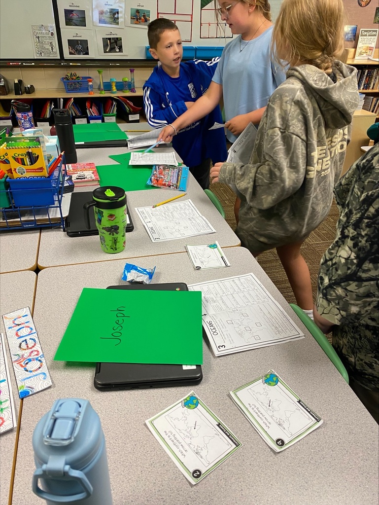 Students standing by tables