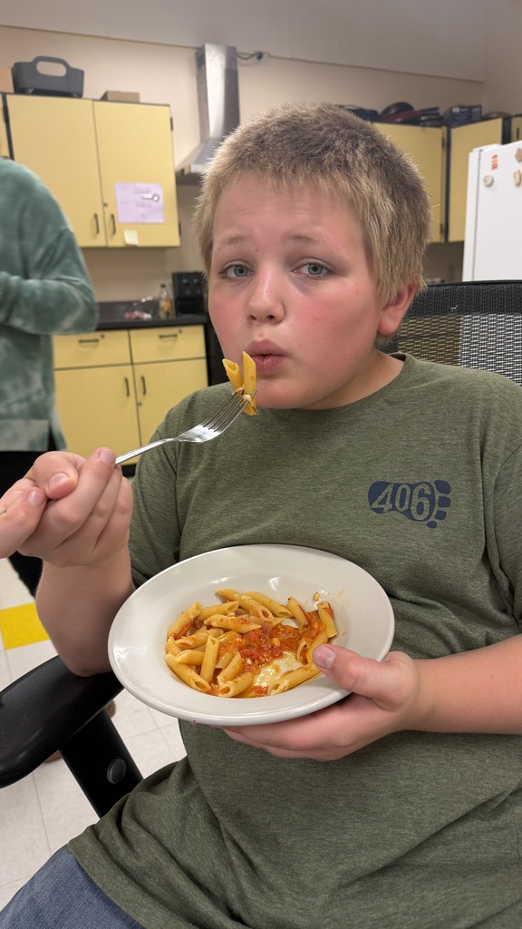 Student blowing on pasta