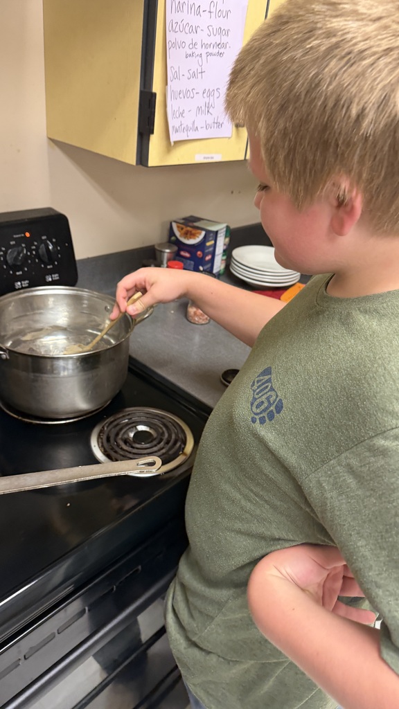 Student standing by oven