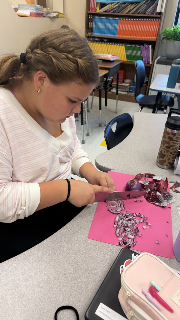 Student cutting onions