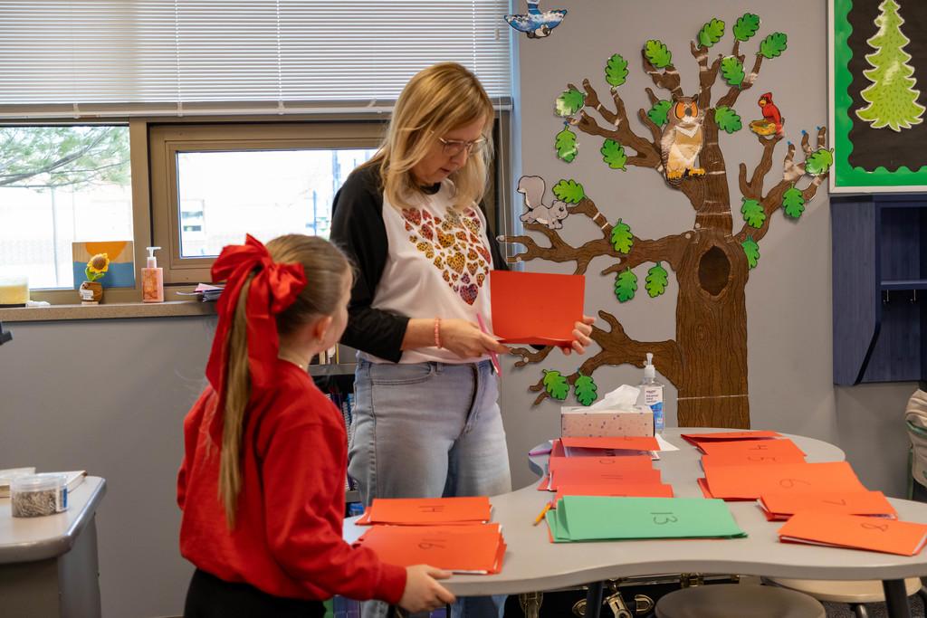 Teacher checking kids answers.