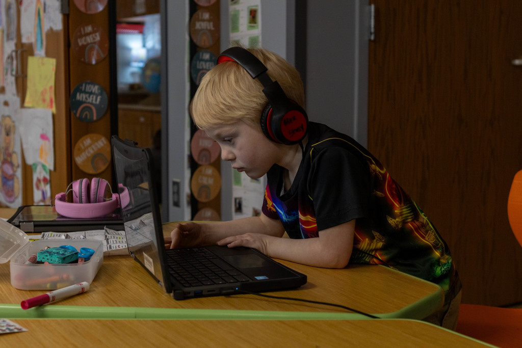 Child playing with computer