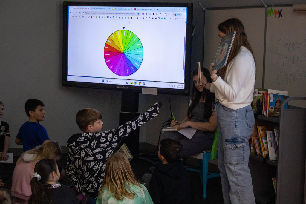 Teacher holding a book.