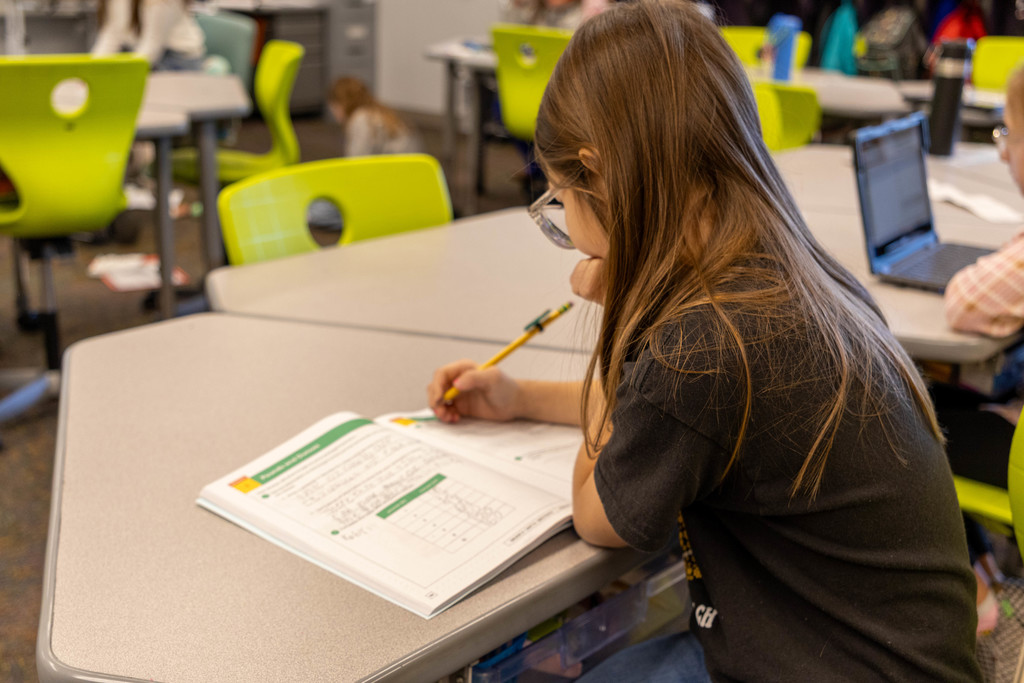 Kid working on math.
