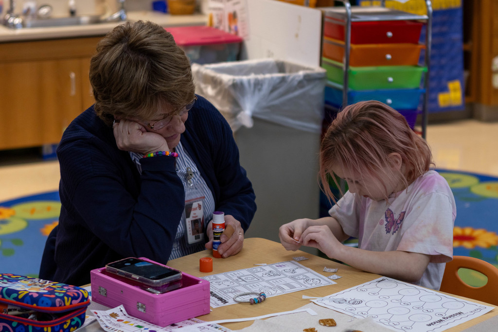 Teacher helping student